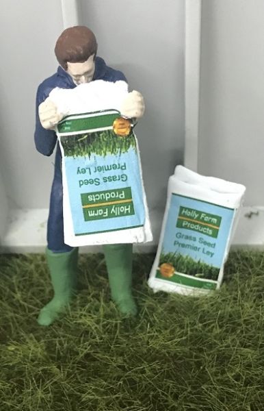 WM078E - Bauer entleert eine Tüte mit Grassamen - 1
